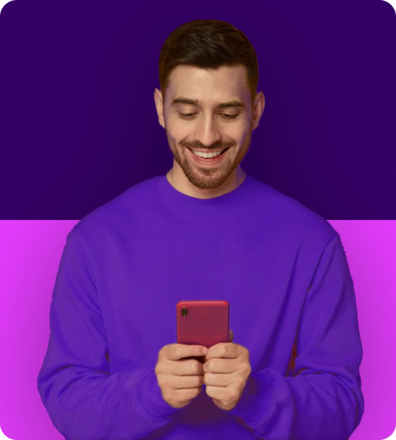 A happy man using an app on his phone